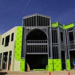 A building under construction with green walls.